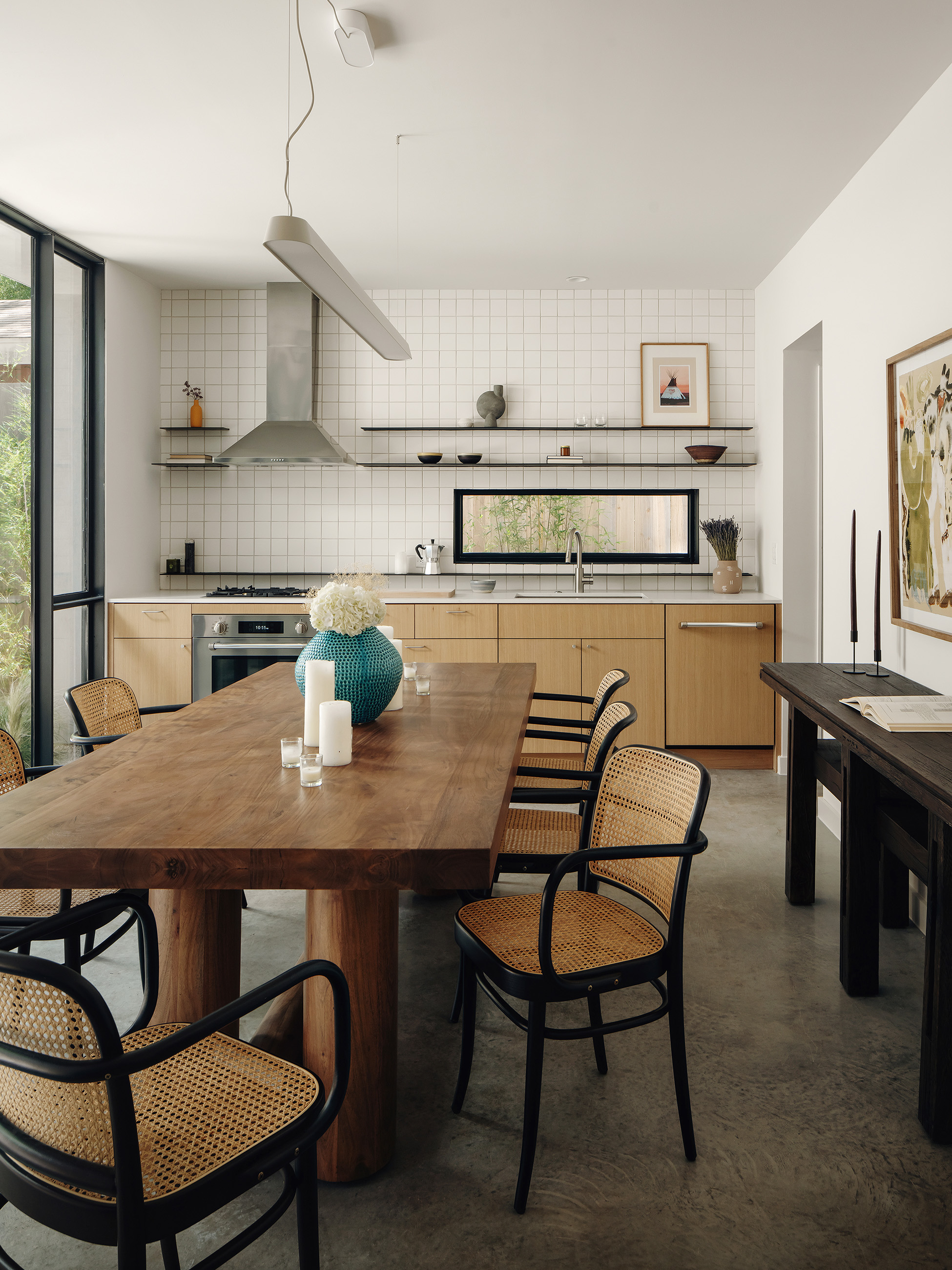 Kitchen with white tile, wood island and bench seating